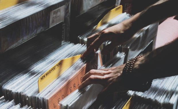 person sorting through vinyl records